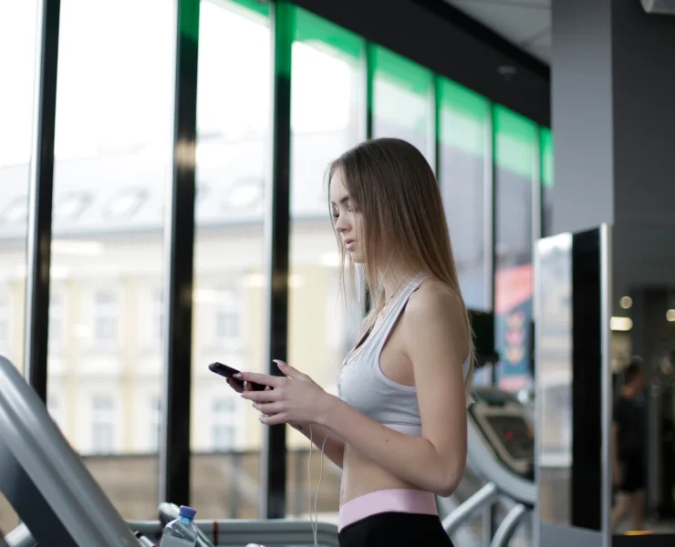 Young woman on treadmill at gym