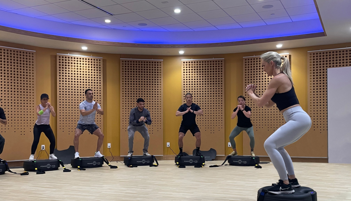 group of people on power plates in a class