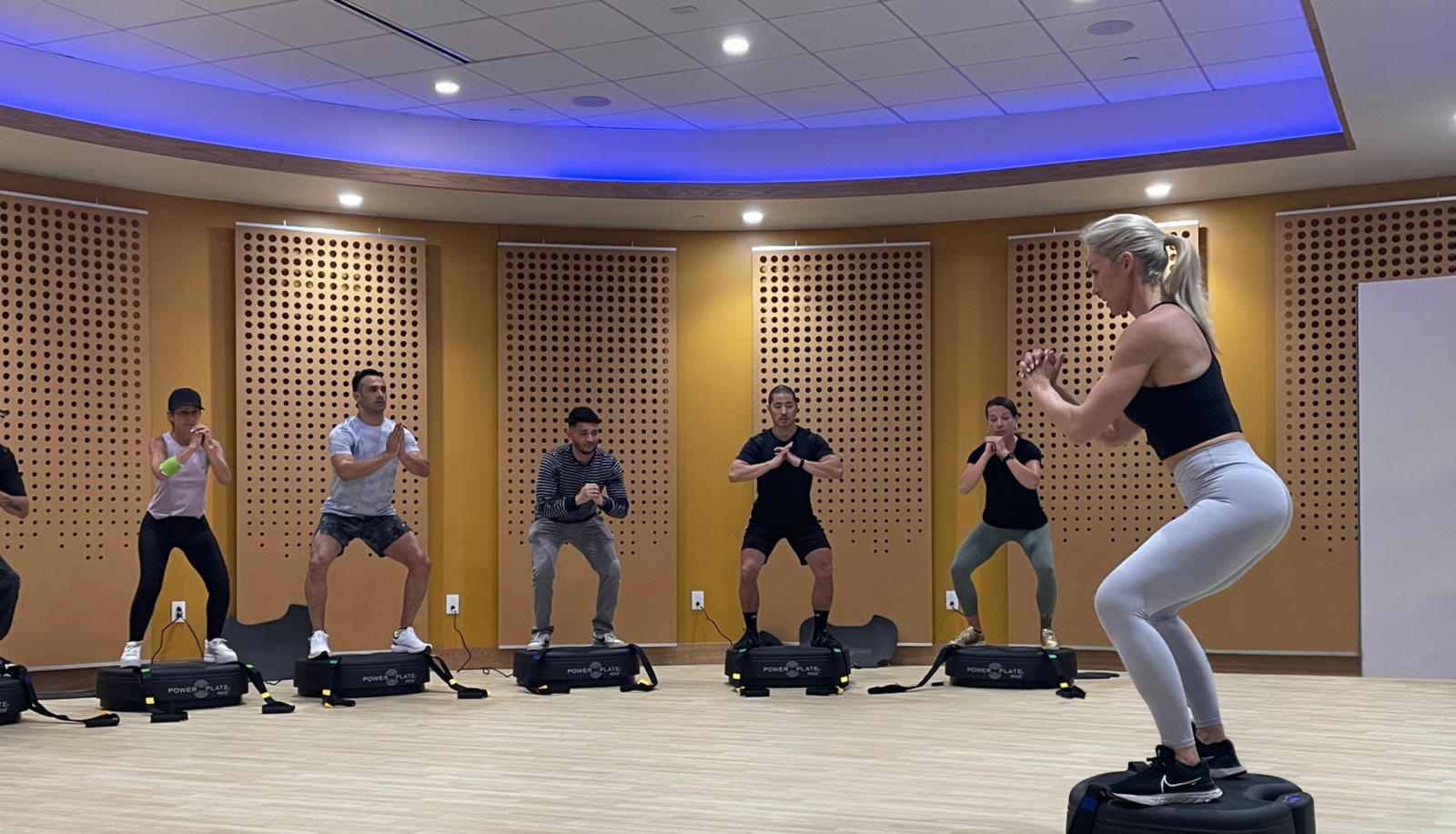 group of people on power plates in a class