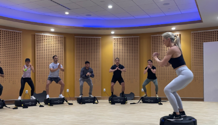 group of people on power plates in a class