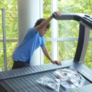 young men installing treadmill