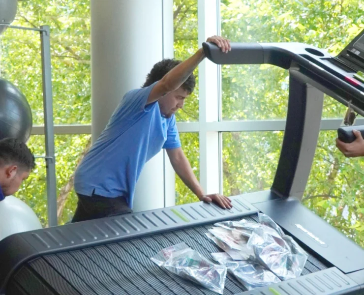 young men installing treadmill