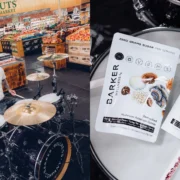 Travis Barker plays drums next to a Barker Wellness product