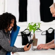 Black lady at desk talking to white man