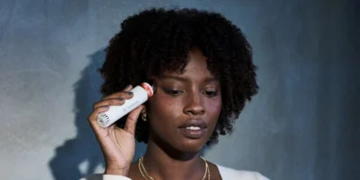 Black woman using Theraface wand