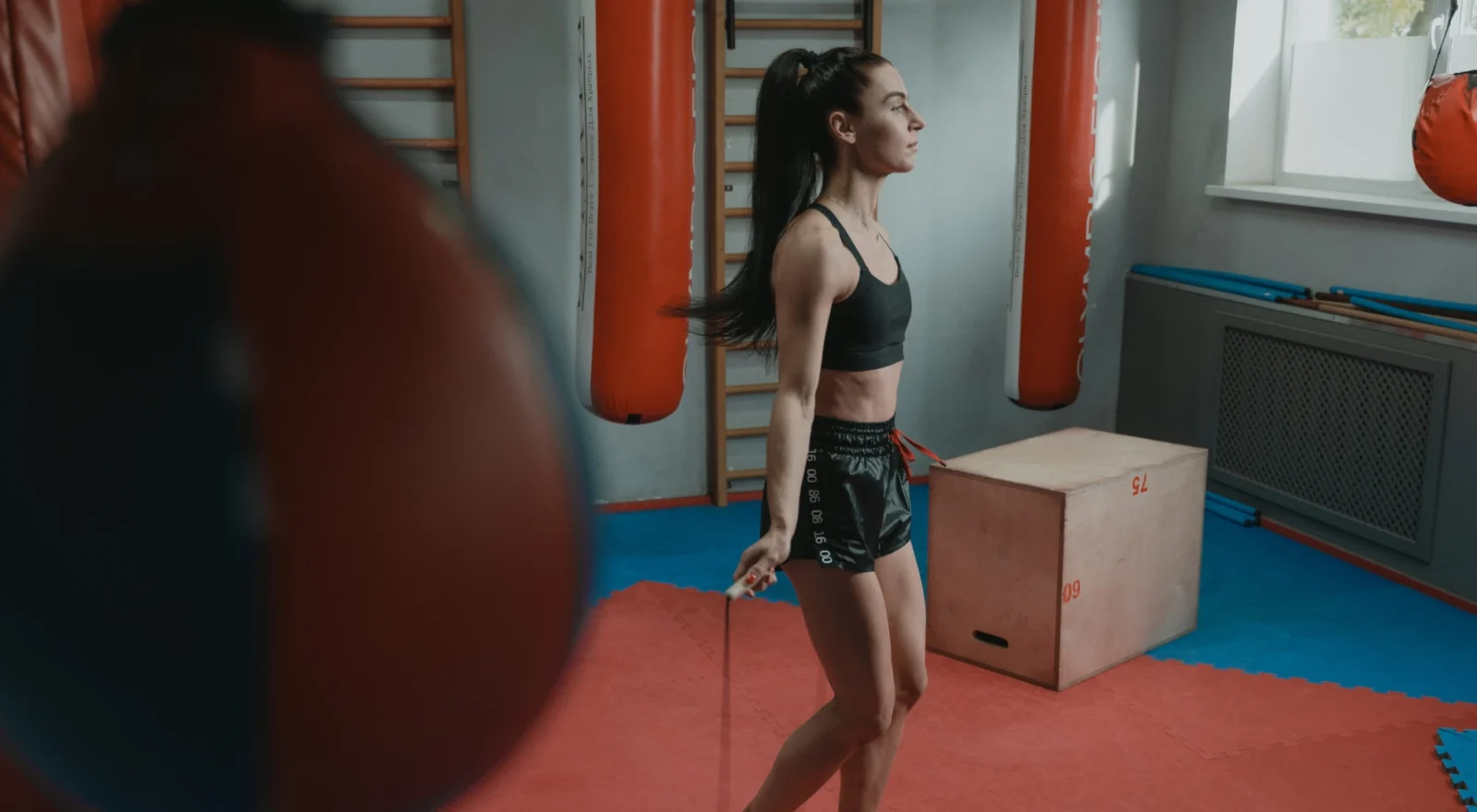 Woman working out in gym, jumping rope