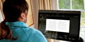 Person riding peloton and reading kindle
