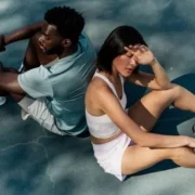 man and woman sitting down on tennis court