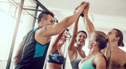 young people at gym giving high fives