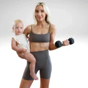 Mother with baby, holding a dumbbell