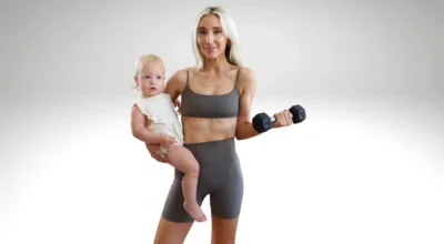 Mother with baby, holding a dumbbell