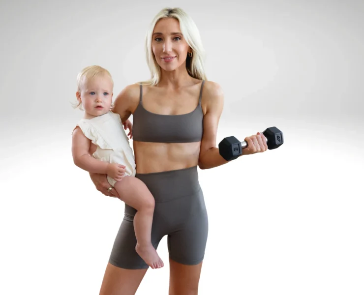 Mother with baby, holding a dumbbell