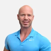 Headshot of a man, Shaun Krenz, in a blue shirt with a friendly expression