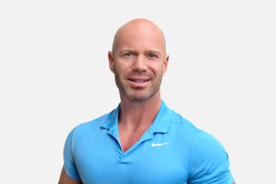 Headshot of a man, Shaun Krenz, in a blue shirt with a friendly expression