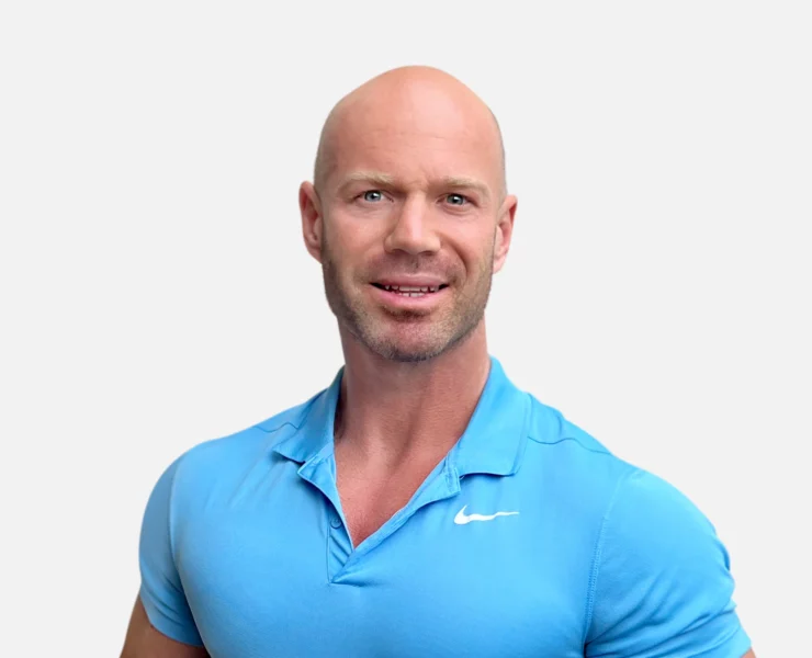 Headshot of a man, Shaun Krenz, in a blue shirt with a friendly expression