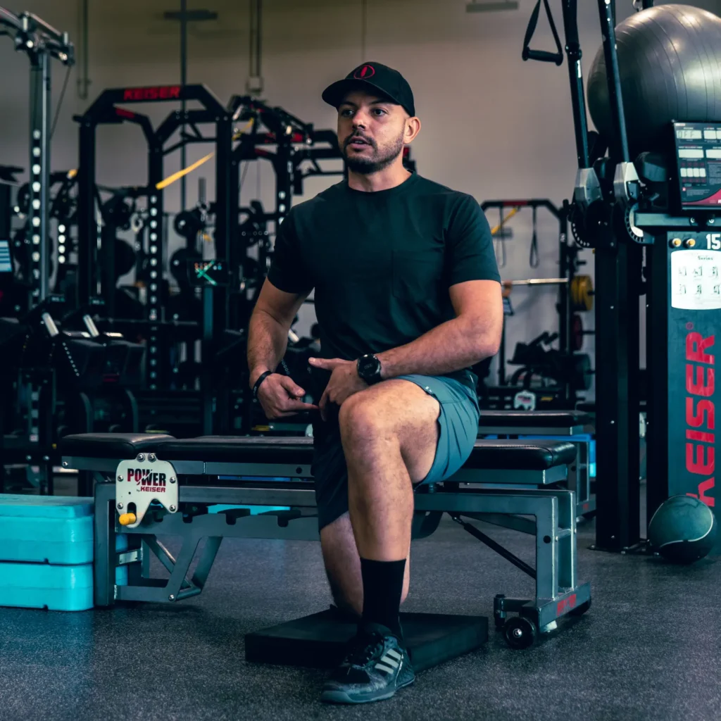 man lifting weights at indoor gym