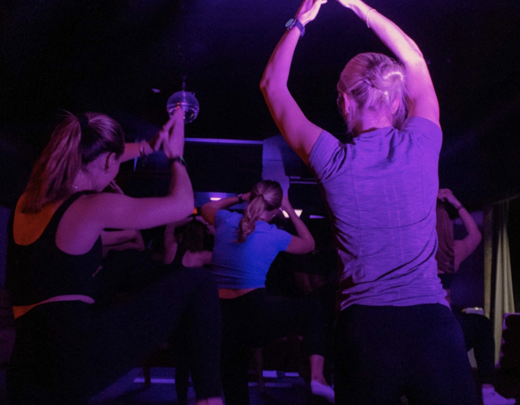 women in indoor cycling class