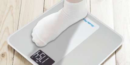 An image of a socked foot stepping on a Smart Meter iScale.