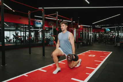 man does a walking lunge inside a Snap Fitness