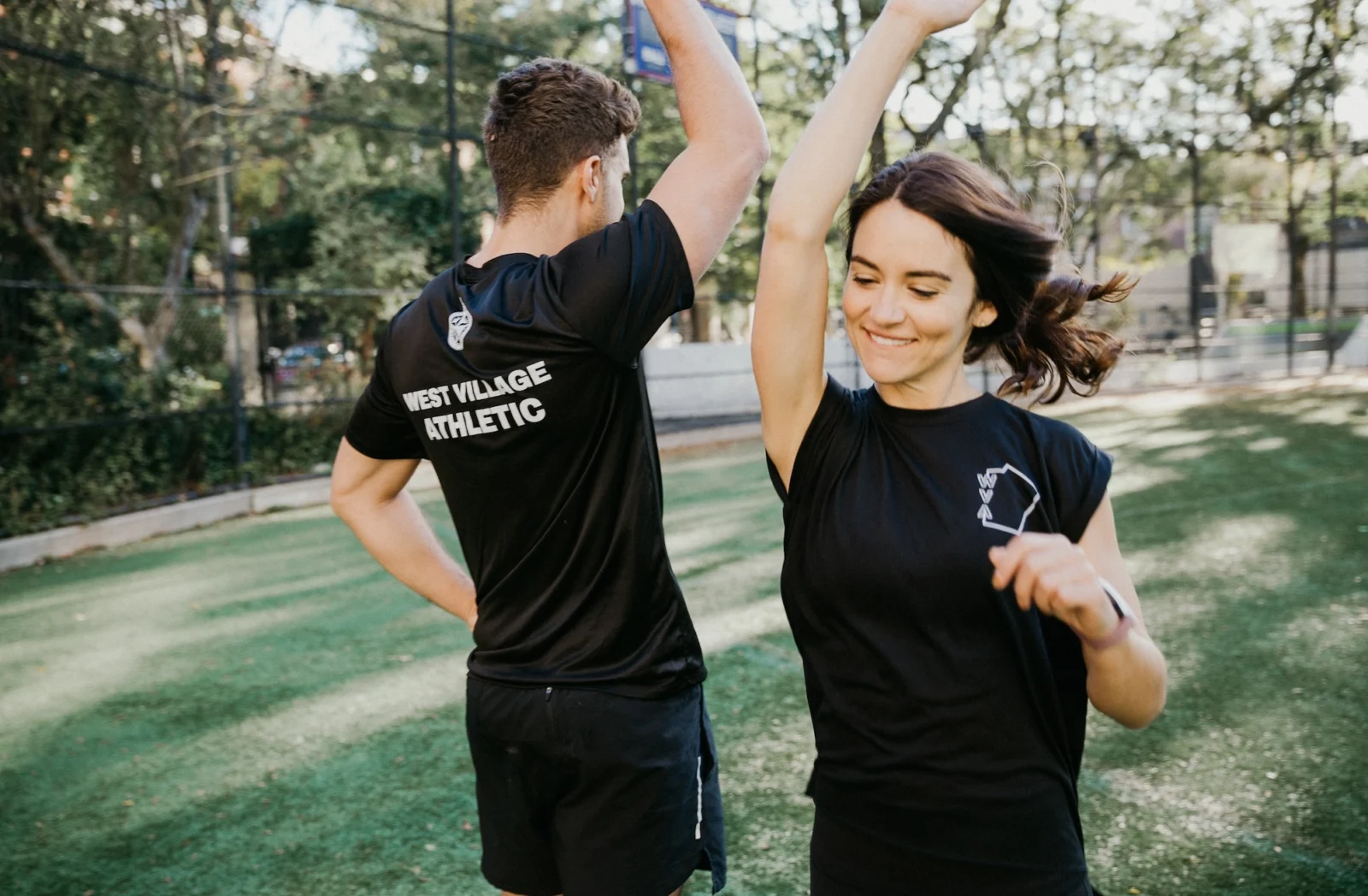 man and woman high five at The Athletic Clubs in West Village