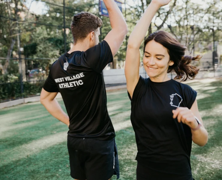 man and woman high five at The Athletic Clubs in West Village