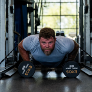 man doing pushups with weights