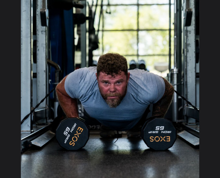 man doing pushups with weights