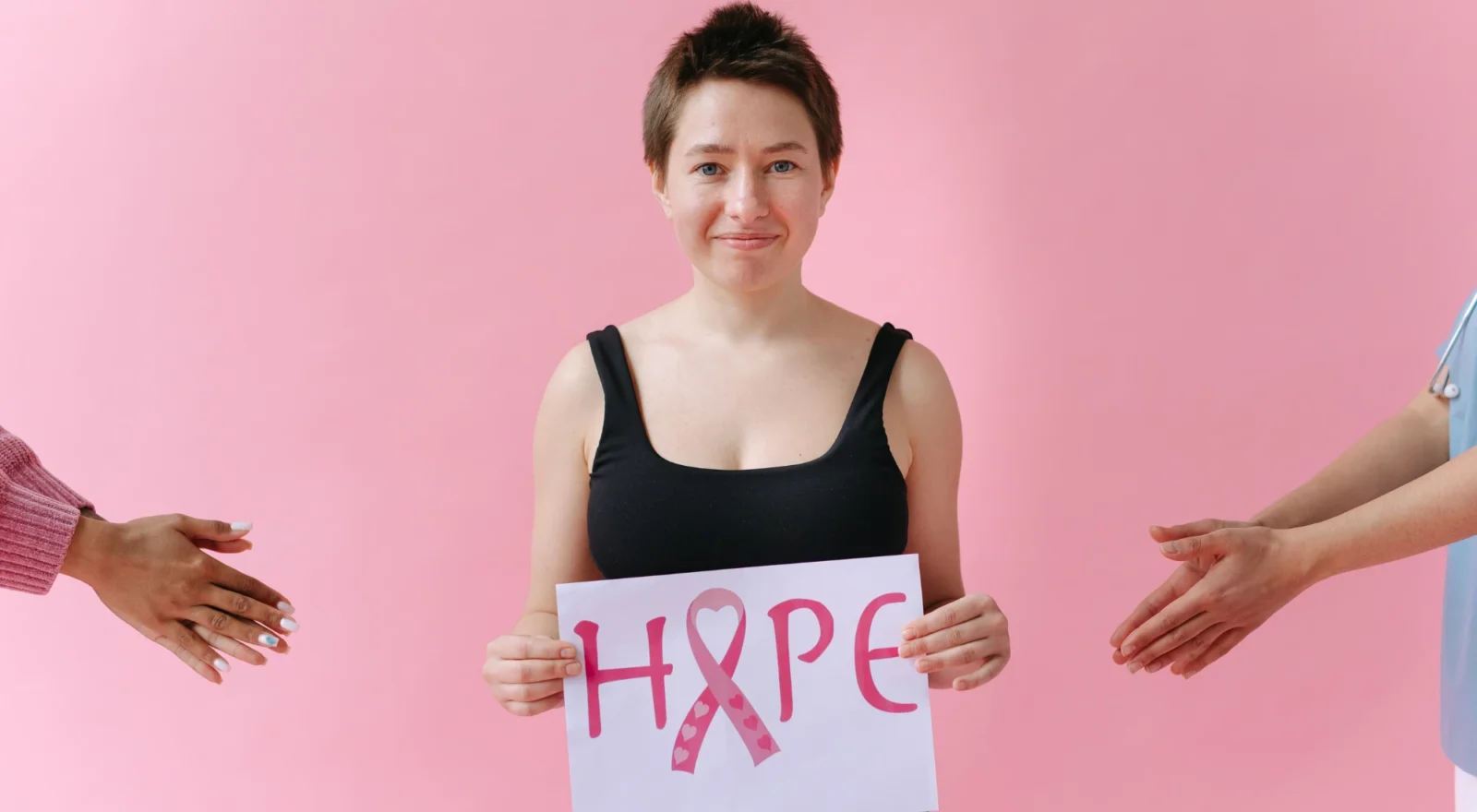 Woman holding sign that says Hope, for breast cancer