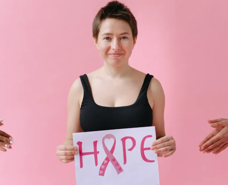 Woman holding sign that says Hope, for breast cancer