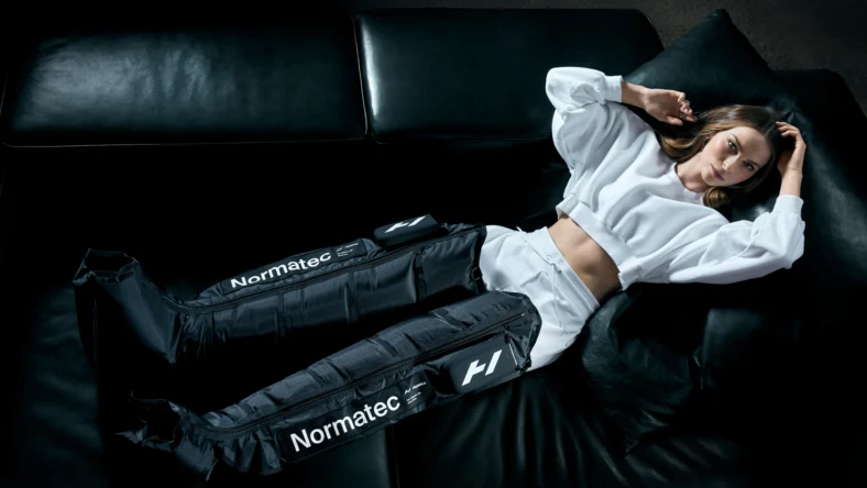 an image of a woman wearing a Hyperice air compression product