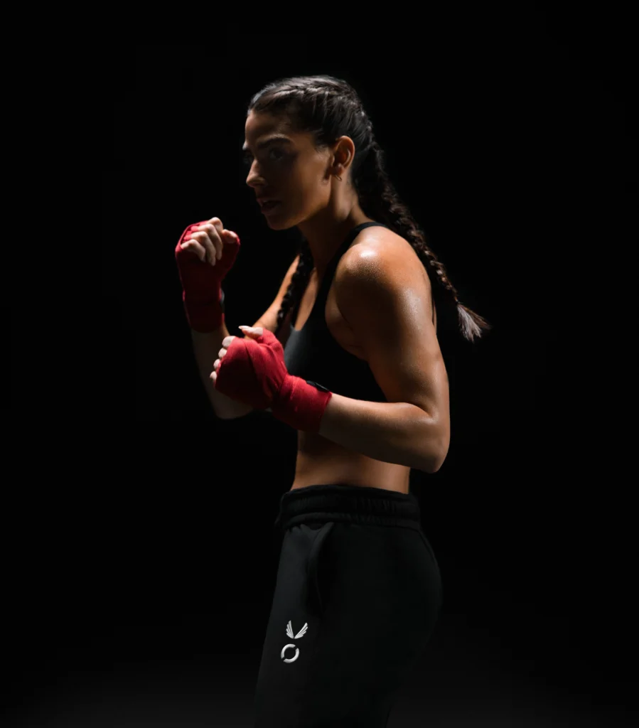 a woman wearing Equinox x ASRV while sporting red boxing gloves