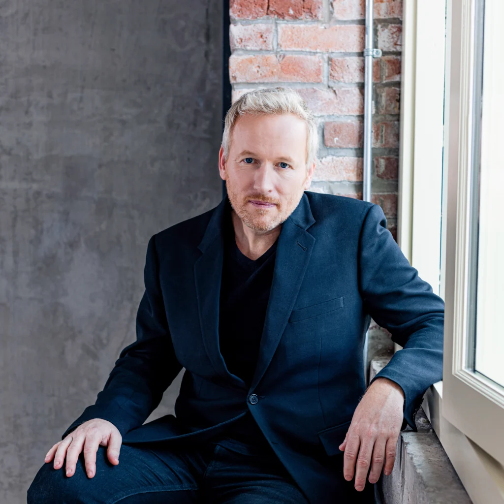 an image of Prenuvo co-founder Andrew Lacy against a brick background