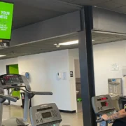 person in gym looking at tv