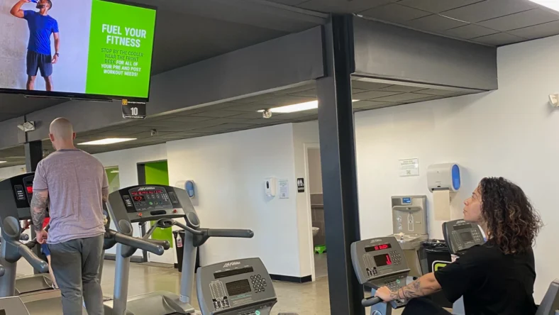 person in gym looking at tv