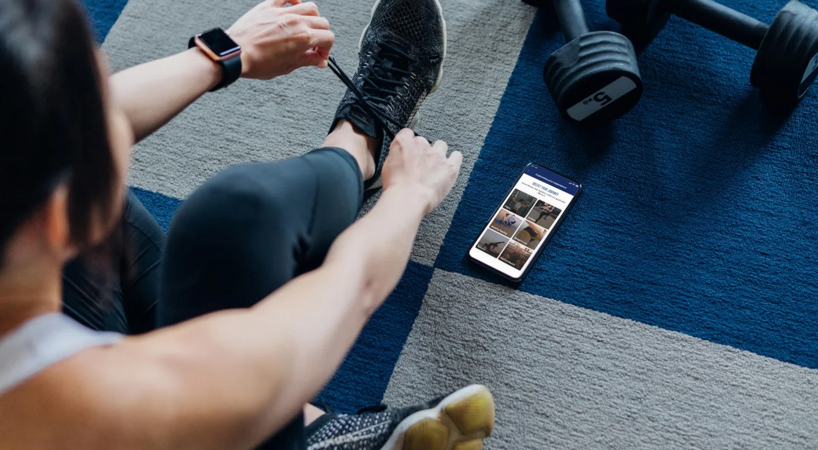 Woman preparing to work out, with phone