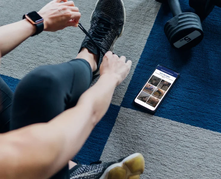 Woman preparing to work out, with phone