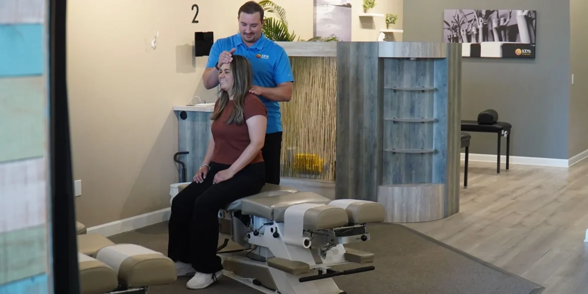 woman gets a back adjustment at a100% Chiropractic office