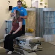 woman gets a back adjustment at a100% Chiropractic office