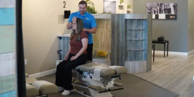 woman gets a back adjustment at a100% Chiropractic office