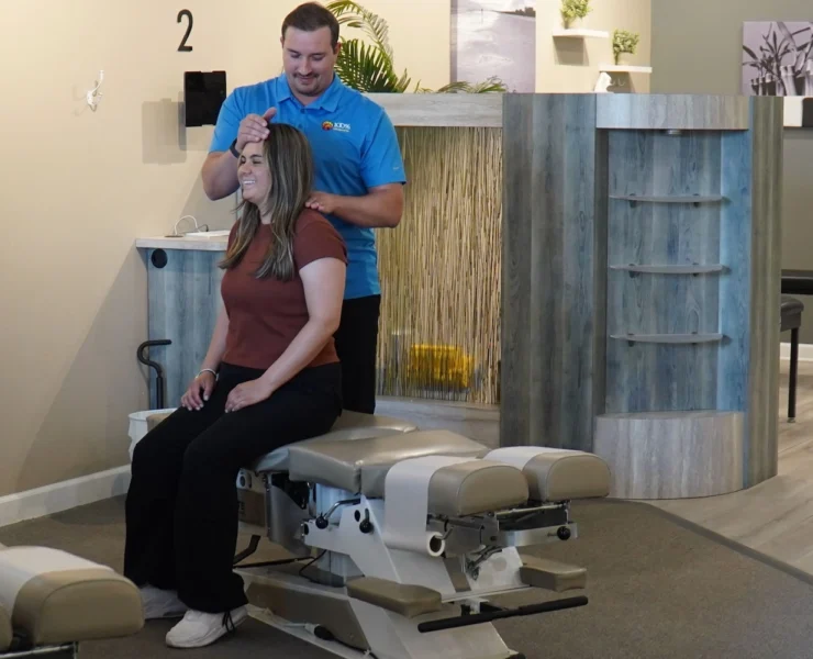 woman gets a back adjustment at a100% Chiropractic office