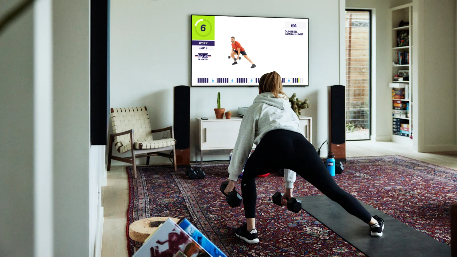 woman working out with F45 at home on a Samsung TV