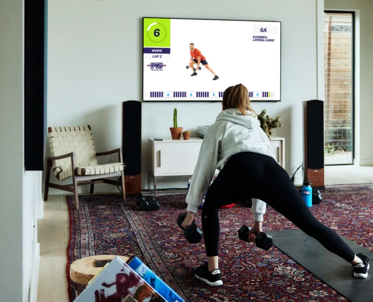 woman working out with F45 at home on a Samsung TV