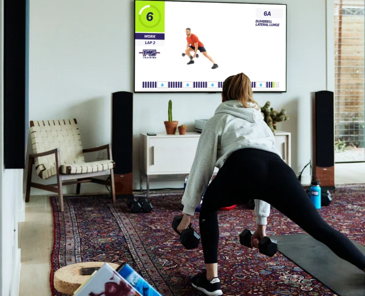 woman working out with F45 at home on a Samsung TV