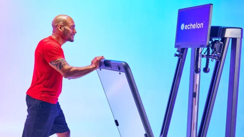 an image of a man in a red t shirt folding the new Echelon Strength Home