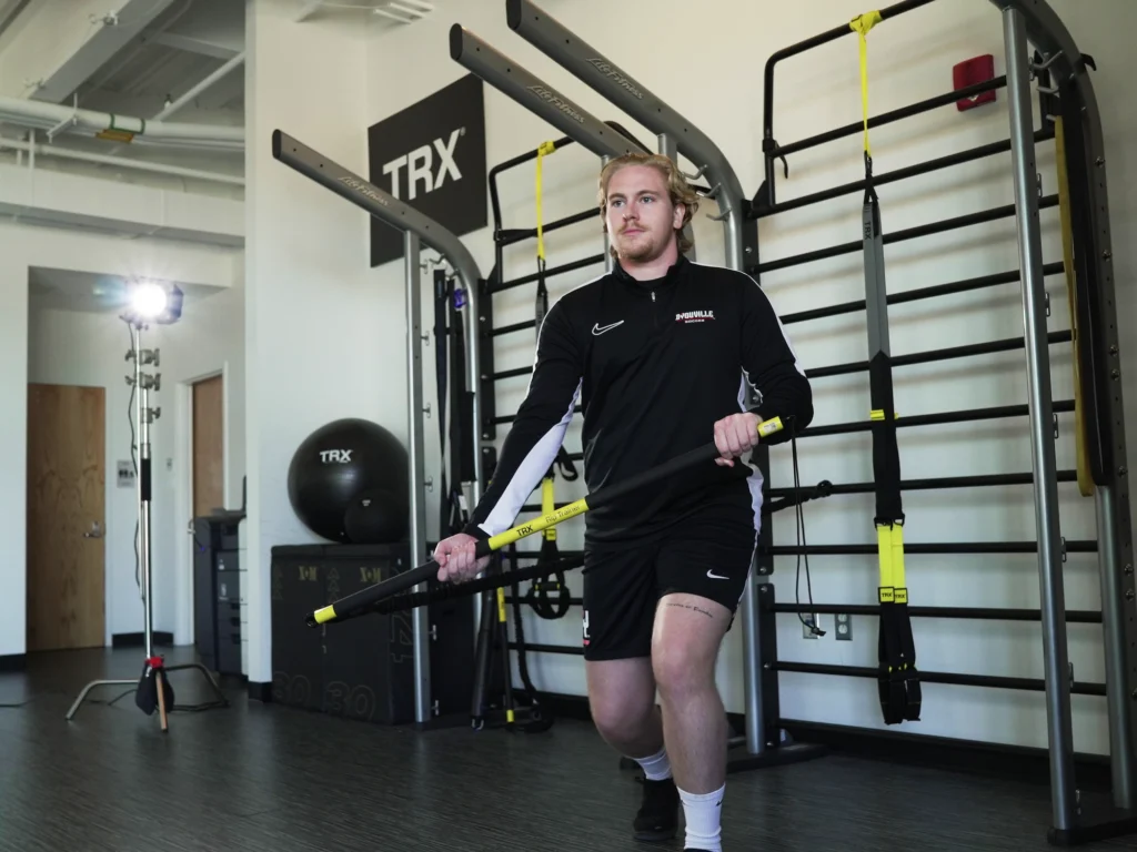 man uses TRX Rip Trainer during physical therapy session