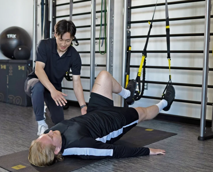 man uses TRX straps during physical therapy session