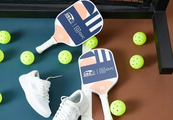 an image of pickleball paddles, balls and sneakers