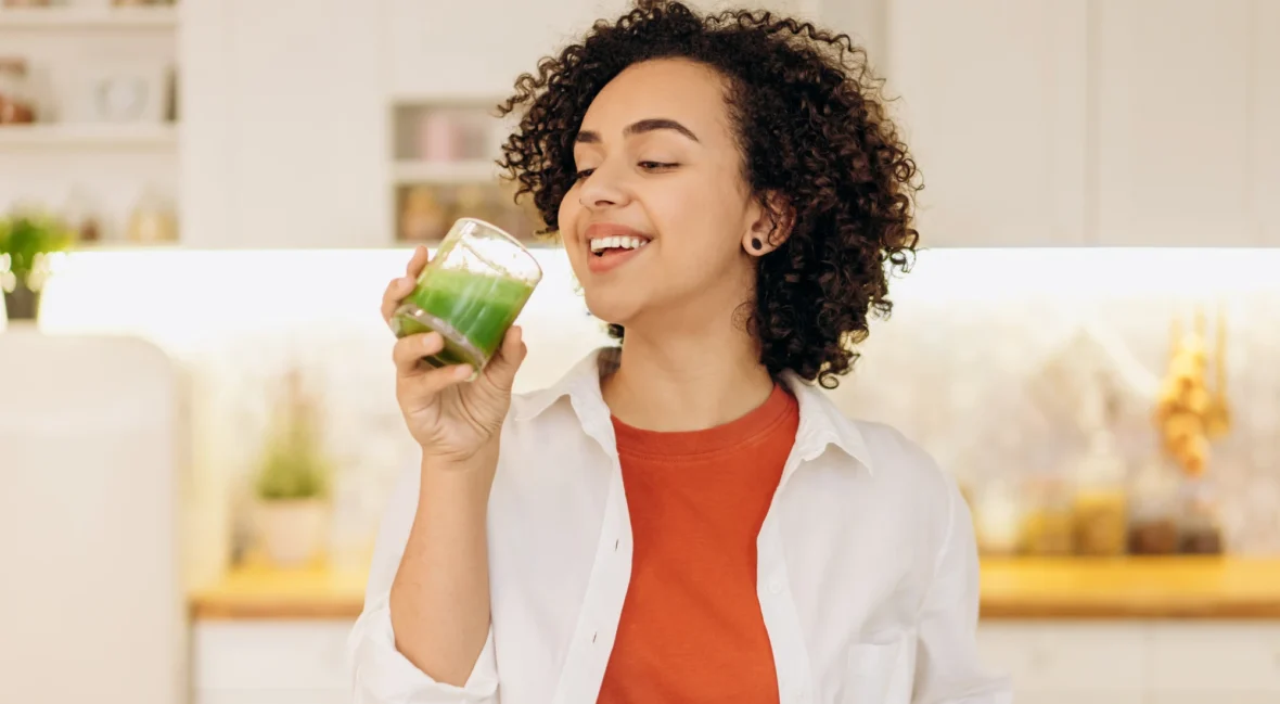 woman drinking greens juice