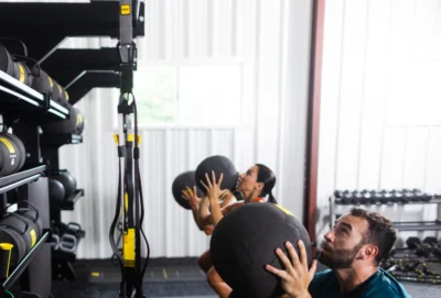 men and women workout with TRX medicine balls