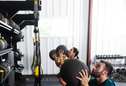 men and women workout with TRX medicine balls